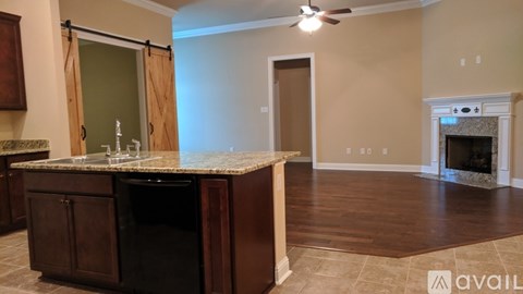 A kitchen with a black dishwasher and a countertop.