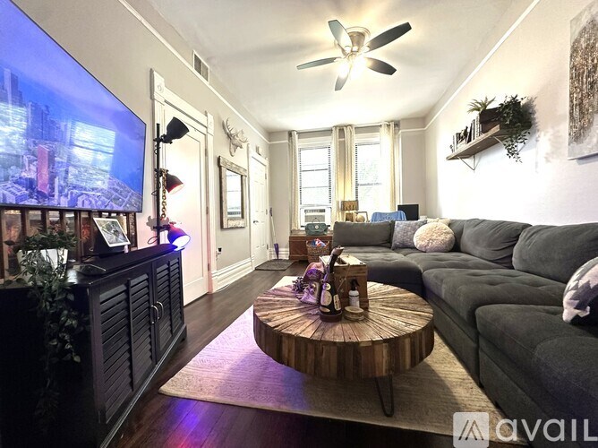 A living room with a grey couch and a wooden coffee table.