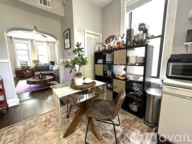 A kitchen with a table and chairs in the middle of the room.