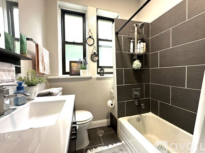 A bathroom with a white sink, toilet, and bathtub.