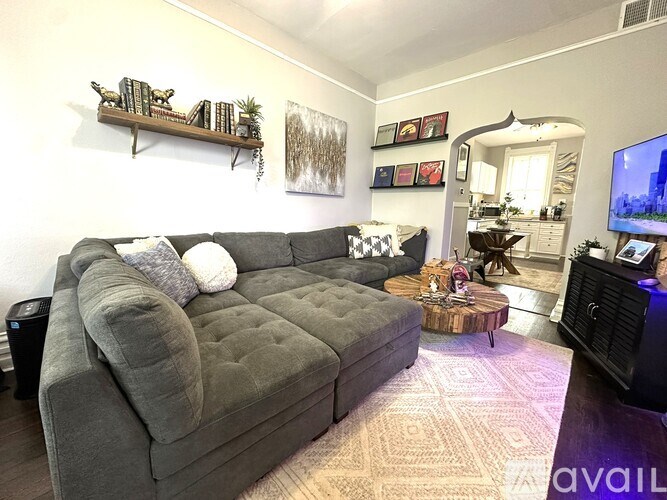 A living room with a grey couch and a coffee table.