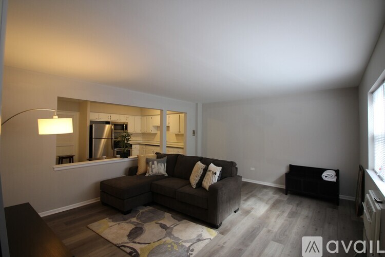 A living room with a couch, a lamp, and a television.