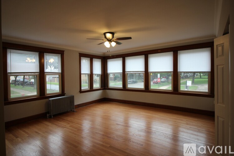 A room with wooden floors and a ceiling fan.