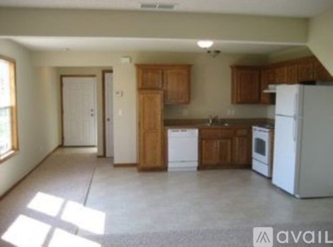 A kitchen with wooden cabinets and a white refrigerator.