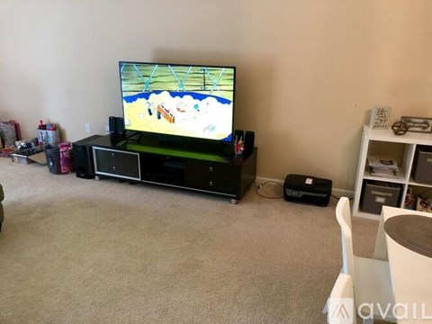 A television is on a stand in a living room.
