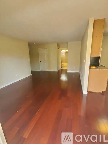 A room with wooden floors and a white wall.