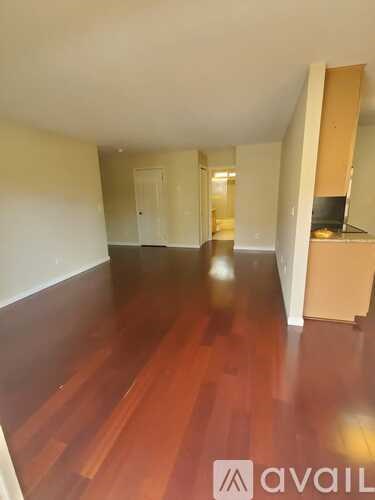 A room with wooden floors and a white wall.