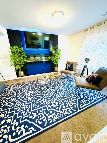 A living room with a patterned rug and a couch.