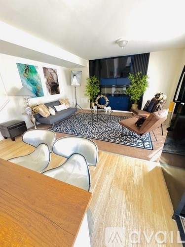 A living room with a grey couch and a wooden table.