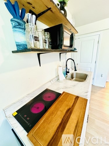 A kitchen with a wooden counter and a microwave on top of it.