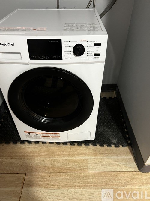 A white washing machine with the door open.