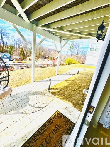 A porch with a doormat that says "welcome" on it.