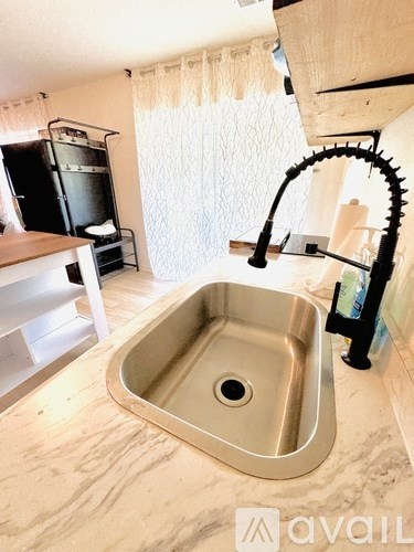 A kitchen sink with a faucet and a countertop.