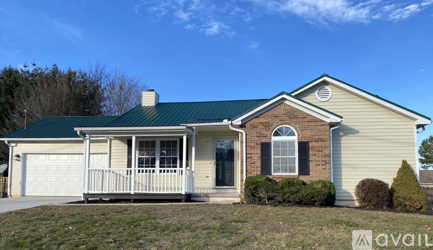 A house with a green roof and a white garage door.