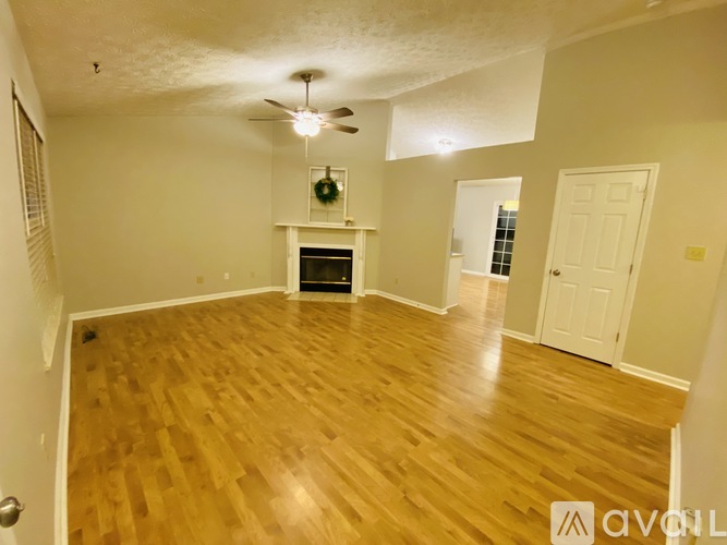 A room with wooden floors and a fireplace.