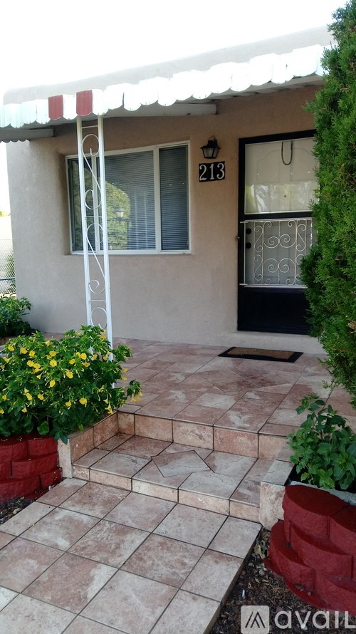 A house numbered 213 has a small front yard.
