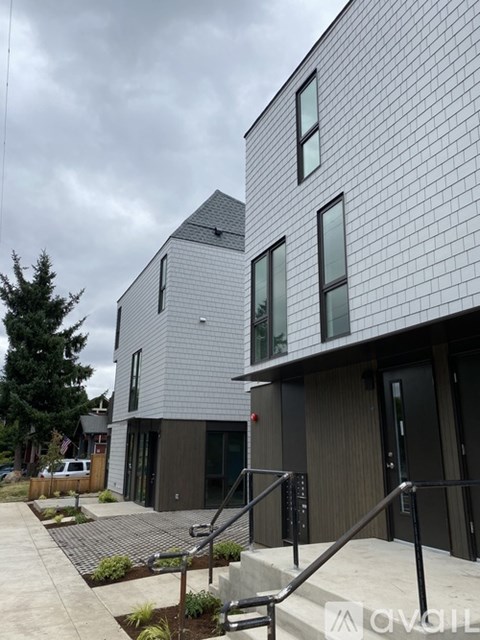 A modern building with a combination of wood and grey panels.