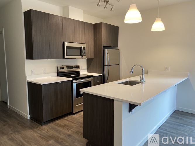 A kitchen with brown cabinets and white countertops.