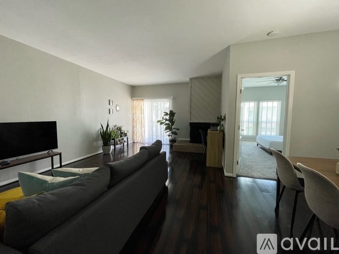 A living room with a grey couch and a television.