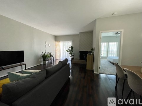 A living room with a grey couch and a television.