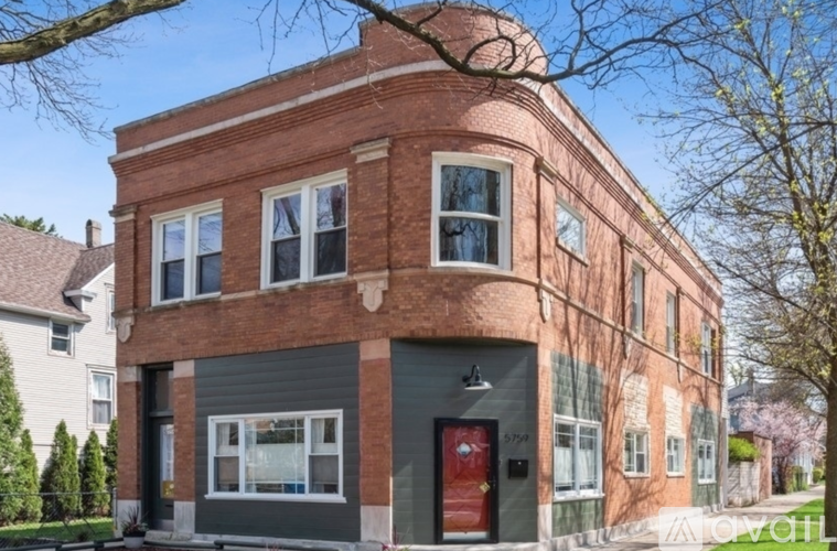A red brick building with a grey garage door.