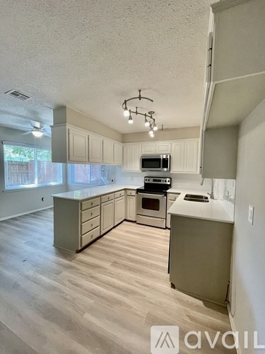 A kitchen with a microwave, oven, and cabinets.