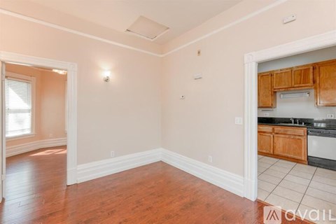 A kitchen area with wooden cabinets and a white countertop.