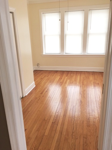 A room with wooden floors and a window.