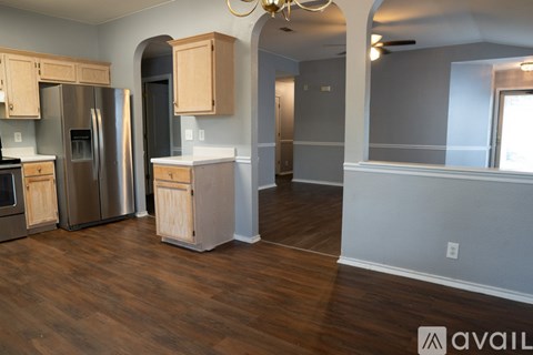 A kitchen with wooden cabinets and stainless steel appliances.