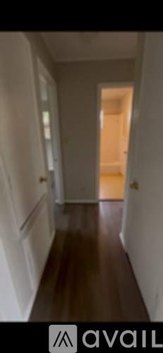 A long hallway with a door at the end.