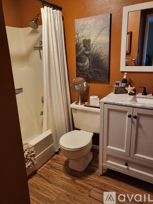 A bathroom with a toilet, sink, and shower.