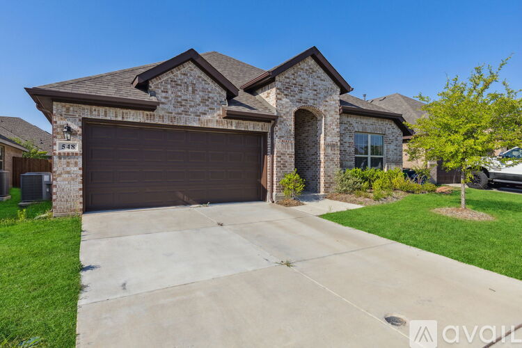 A house with a garage door and a driveway.