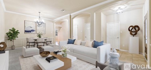 A living room with a white couch and a coffee table.