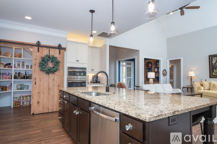 A kitchen with a large island and a wreath hanging on the door.
