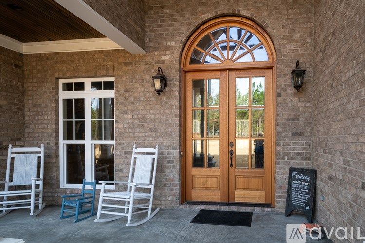A wooden door with a glass window is the main focus of the image.