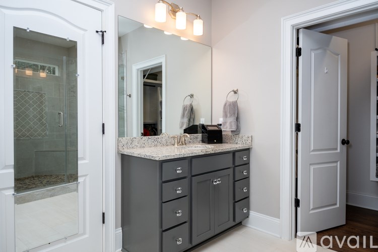 A bathroom with a vanity and a mirror.