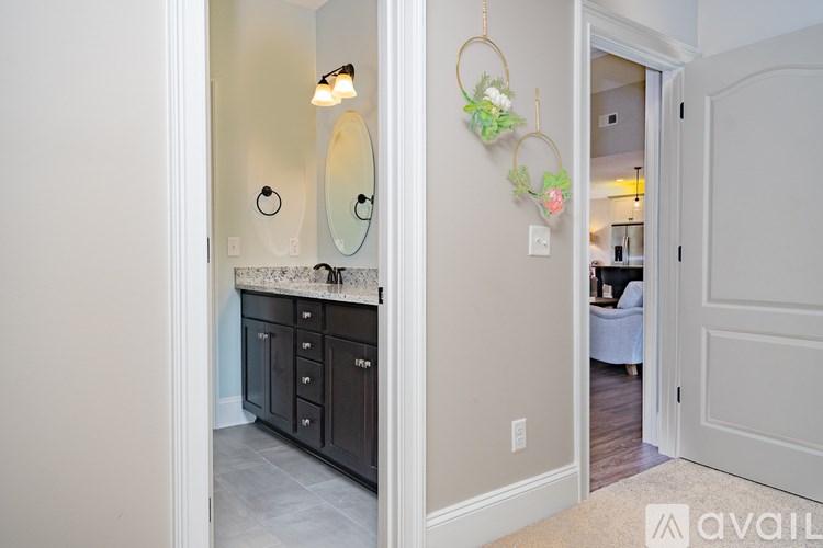 A bathroom with a vanity and a mirror above it.
