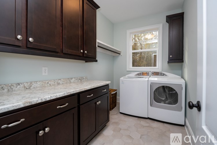 A kitchen with brown cabinets and a white countertop.