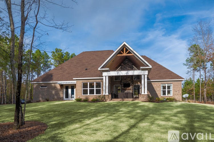 A house with a brown roof and a large front yard.