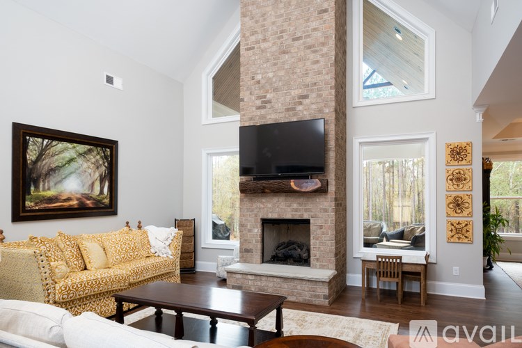A living room with a fireplace and a television.