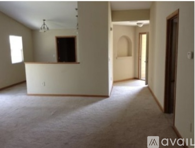 A spacious room with a white counter and a window.