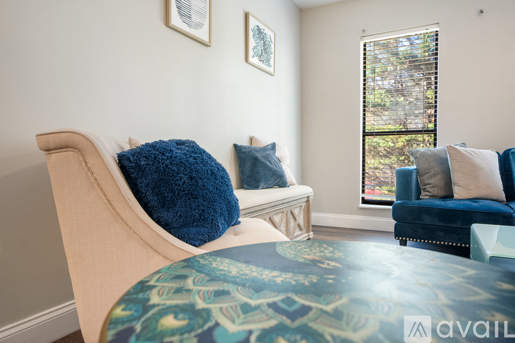 A living room with a sofa, a chair, and a table.