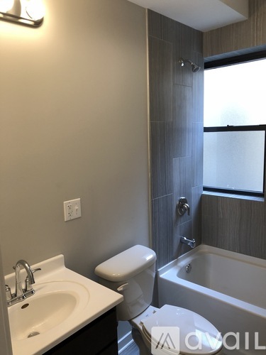A white sink is on a counter next to a toilet.