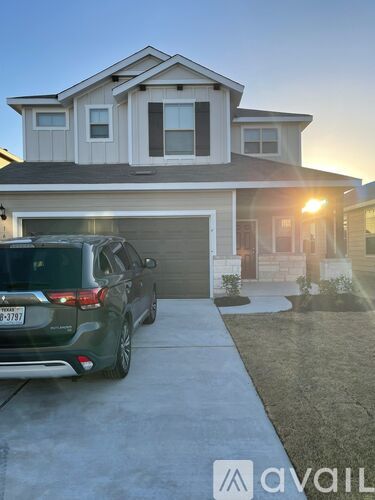 A house with a car parked in front of it.