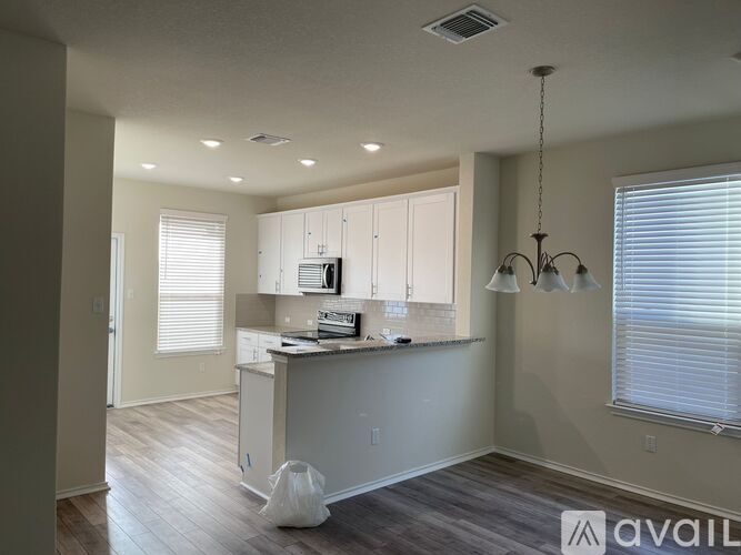 A kitchen with a bag on the floor.