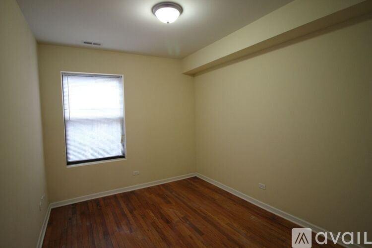 A room with a window and wooden flooring is available for rent.