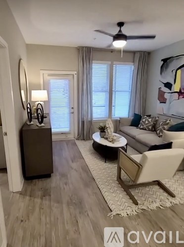 A living room with a white sofa and a wooden coffee table.