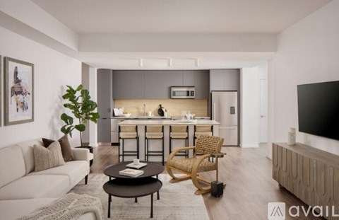 A kitchen with white cabinets and a white island with a bowl of fruit on it.