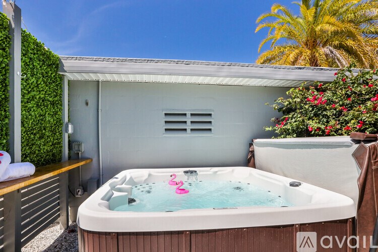 A hot tub sits in the middle of a patio area.