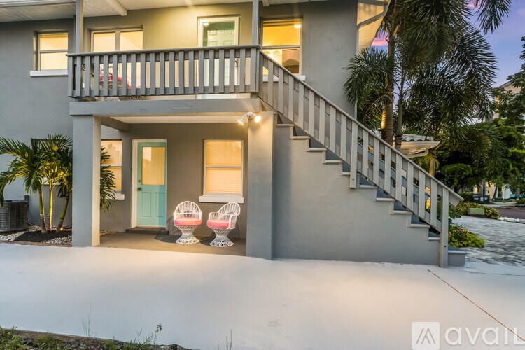 A house with a balcony and stairs leading to the second floor.